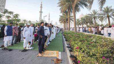 Worshippers celebrate Eid Al Fitr outside Sheikh Zayed Mosque early on Tuesday morning.