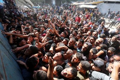 Palestinians gather to buy bread in Deir Al Balah, central Gaza, amid shortages worsened by limited aid deliveries. Reuters