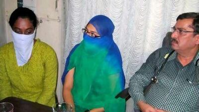 Shaheen Dhada, centre, and Renu Srinivas, both with their faces covered, were arrested over a Facebook post and a ‘like’.