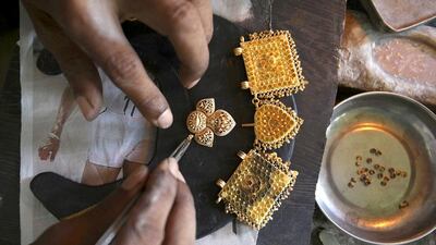 An Indian goldsmith makes jewellery in Gauhati, India. Anupam Nath / AP Photo