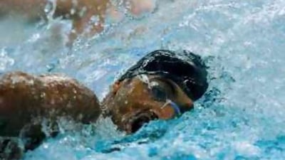 The UAE swimmer Obaid Ahmed Obaid turns to breathe during the men's 100m freestyle swimming heat at the National Aquatic Centre in Beijing.