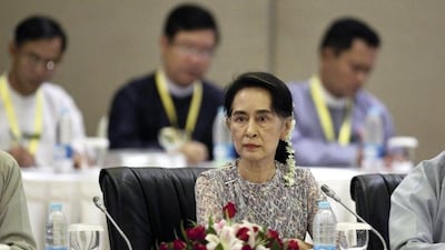 Myanmar's Aung San Suu Kyi (C) looks on at a meeting in Naypyitaw. Ms Suu Kyi is leading a delegation to China EPA/HEIN HTET