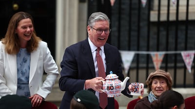 Mr Starmer and his wife Victoria serve tea and cake during a street party in Downing Street to mark the 80th Anniversary of VE Day, in May 2025. Getty Images