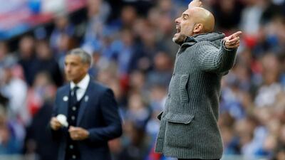 Manchester City manager Pep Guardiola reacts as Brighton manager Chris Hughton looks on. Reuters