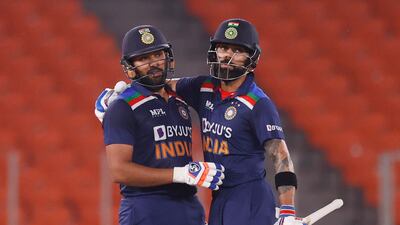 India's Rohit Sharma, left, celebrates his half century with Virat Kohli. Reuters