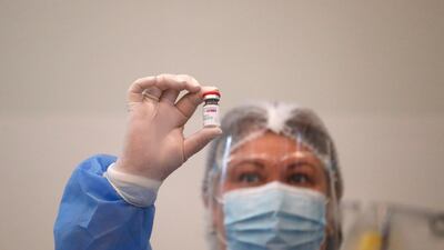 A health worker looks at the AstraZeneca vaccine in Tbilisi, Georgia. A shipment of 43,200 doses of AstraZeneca vaccine arrived in Georgia on 13 March as some countries temporarily halted the use of the jab. EPA