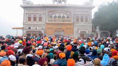 Sikh devotees pay their respects on the occasion of New Year Day amid foggy conditions at the Golden Temple in Amritsar. AFP