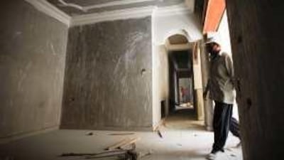 A construction worker at a new apartment in east Amman, where prices remain high.