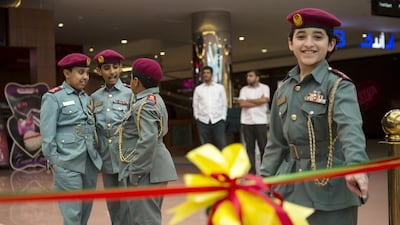Children dressed as police officers attend the opening ceremony of an exhibition at Mushrif Mall as part of Gulf Traffic Week organised to reduce road accidents. Christopher Pike / The National