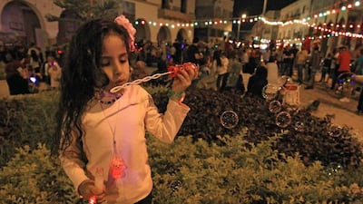 A girl blows bubbles as Muslims celebrate the birthday of Prophet Mohammed, known as "al-Mawlid al-Nabawi", in Libya's eastern city of Benghazi. AFP