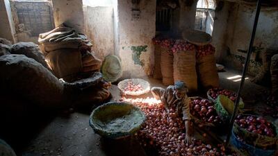 The onion man: a worker sorts through onions at a wholesale vegetable shop in Rawalpindi, Pakistan. Anjum Naveed / AP Photo