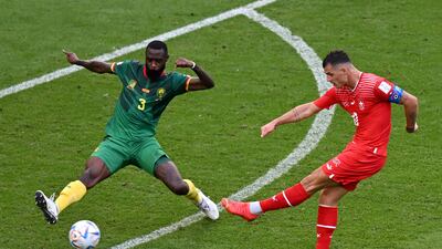Cameroon defender Nicolas Nkoulou attempts to block a shot by Granit Xhaka of Switzerland. AFP