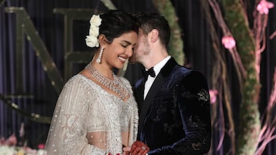 Newlyweds Priyanka Chopra, 36, and Nick Jonas, 26, pose for a photograph during a reception at a hotel in New Delhi on December 4, 2018. Photo: EPA