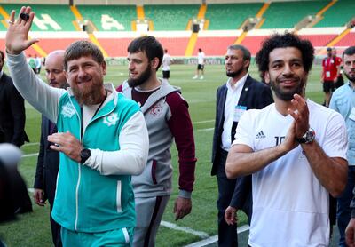 Egypt's star striker Mohammed Salah, right, and Chechen regional leader Ramzan Kadyrov greet football fans as they arrive to attend Egypt's training session in Grozny, Russia. AP
