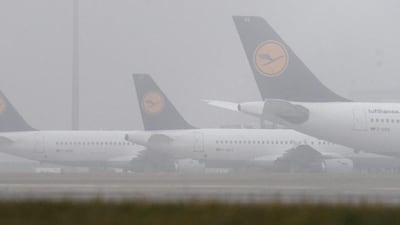 Lufthansa airplanes are seen in the fog at the airport in Munich, Germany, 24 November 2016. Numerous planes have been cancelled on the second day of the pilots' strike at Lufthansa. Stefan Puchner / EPA