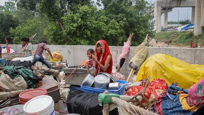 A woman with her belongings after being displaced by rising water levels in New Delhi, India. Reuters