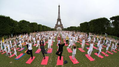 People gather for an open-air yoga session near the Eiffel tower in Paris. Philippe Wojazer / Reuters