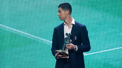 Cristiano Ronaldo stands with the trophy at the Gran Gala del Calcio 2019 ceremony. AP Photo
