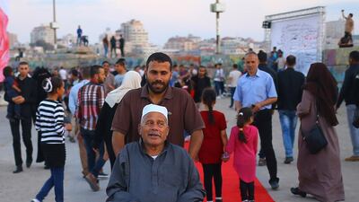Palestinians walk on the red carpet during the film festival in 2017, held at the fisherman's wharf. AFP.