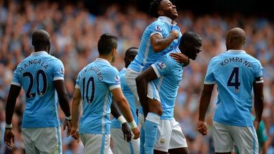 Manchester City's Raheem Sterling celebrates with teammates after scoring their first goal in a victory over Watford on Saturday at the Etihad Stadium. Tony Marshall / Getty Images