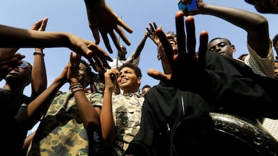 Sudanese people chant slogans as they celebrate the power sharing agreement. Reuters