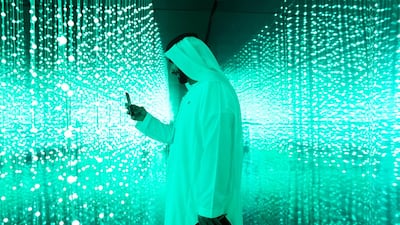 A man takes a photo of the light installation at "You Are Light" exhibit by Mohammed Bin Rashed Centre for Government Initiation, showing at World Government Summit 2018. Reem Mohammed / The National
