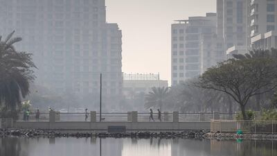 Residents of The Greens walk along the lakes that are a main feature of the neighbourhood. Antonie Robertson / The National