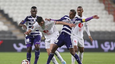 Al Ain’s Ibrahim Diaky, left, and Helal Saeed make their presence felt against Al Jazira on Friday night. Al Ittihad