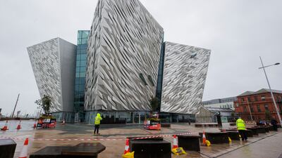 Staff outside the Titanic Belfast visitor attraction which has temporarily shut due to damage to its roof, in Northern Ireland. PA
