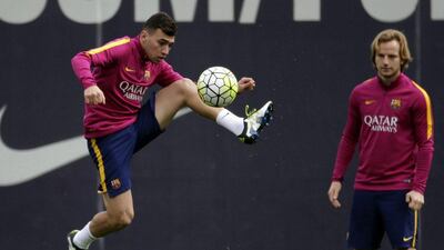 Munir el Haddadi, left, and Ivan Rakitic, right, take part in a team training session. Alberto Estevez / EPA