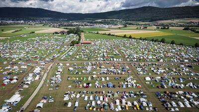 Car enthusiasts gather for the 18th world meeting of Citroen 2CV friends near Delemont, Switzerland. AFP