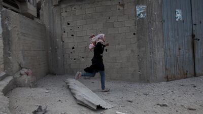Sixty of those victims died in the neighbourhood of Shejaiya which lies between Gaza City and the border. Seen here is a Palestinian woman running for cover in the Shujaieh neighbourhood which has seen heavy shelling.