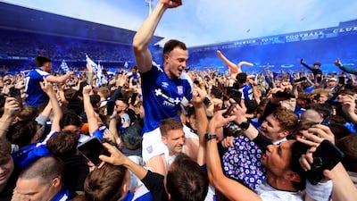 Ipswich Town players celebrate promotion on the pitch. Getty Images