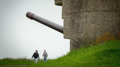 People look at the German guns at the battery at Longues-sur-Mer in Normandy.