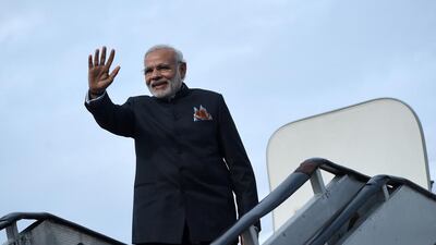 Indian Prime Minister Narendra Modi waves as he boards an aeroplane at the Kabul International Airport on December 25, 2015. Modi, on his visit to Kabul, inaugurated a swanky new parliament complex at an estimated 90 million dollars and gifted three Russian-made attack helicopters to the Afghan government. AFP PHOTO / Wakil Kohsar