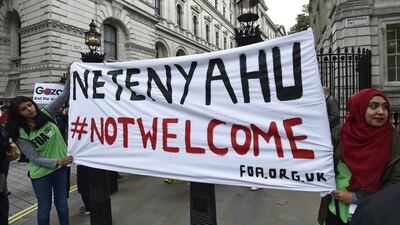 Demonstrators hold a banner that reads 'Netanyahu Not Welcome' during a protest outside Downing Street in London. Toby Melville / Reuters