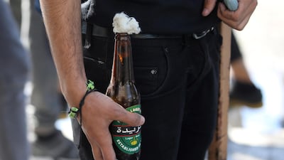 A molotov cocktail is held by an Iraqi demonstrator during ongoing anti-government protests in Baghdad, Iraq. Reuters