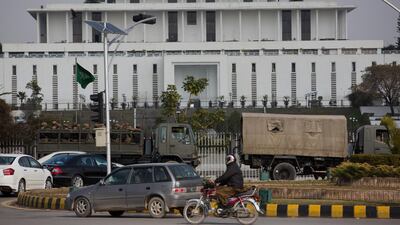 Pakistan Army trucks park outside a presidential palace as security is increased in Islamabad. AP Photo