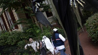 A Post Office employee walks past Halloween decorations in Washington. AFP