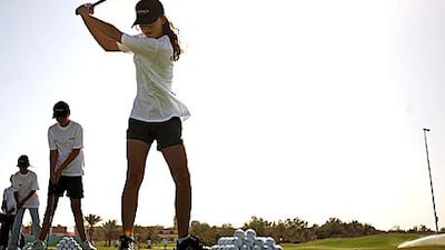 Vlada Alexeeva, a Raha International School sixth grader, tees off at Abu Dhabi Golf Club during an Etihad Airways "My First Golf Swing" course.