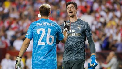 Real Madrid goalkeeper Thibaut Courtois greets Arsenal goalkeeper Emiliano Martinez at the conclusion of the second half. EPA