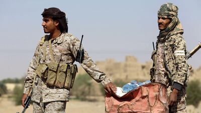 Yemeni tribesmen from the Popular Resistance Committees, loyal to the Saudi president, stop cars at a makeshift security checkpoint along a desert road in the Beihan district in Shabwa province on December 18, 2017. AFP