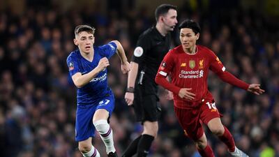 Billy Gilmour dribbles the ball away from Takumi Minamino. Getty Images