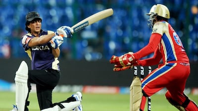 Shah Rukh Khan plays a shot during a friendly match between the members of the support and administrative staff of Royal Challengers Bangalore and his Kolkata Knight Riders cricket team. Dibyangshu Sarkar / AFP