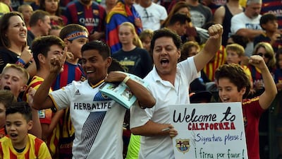 Fans from Barcelona and LA Galaxy cheer before the International Champions Cup pre-season friendly between the teams on Tuesday. Mark Ralston / AFP