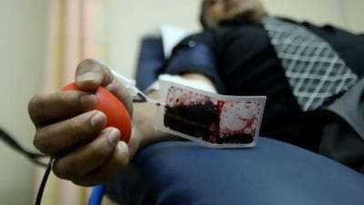A blood donor contributes at Dubai Blood Donation Centre. Residents with negative blood types are particularly encouraged to give. Pawan Singh / The National