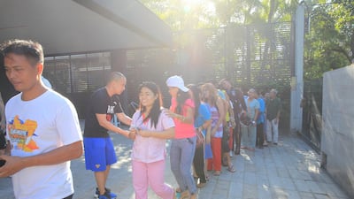 Fans and well-wishers line up in Manny Pacquiao's residence to receive "blessings" for Christmas. Each person receives one thousand pesos as a gift. Jake Verzosa for The National