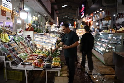 A man works in his shop in Tehran. Reuters