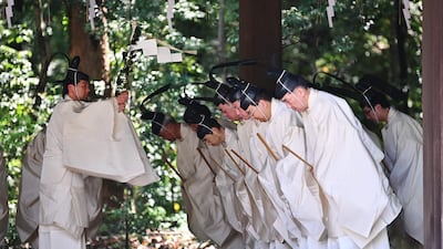 Shinto priests recite religious words before entering the main building to conduct a festive ceremony to report the enthronement of the new emperor to the royal family's ancestors at Meiji Shrine in Tokyo.. Japan's new Emperor Naruhito formally ascended the Chrysanthemum Throne, a day after his father abdicated from the world's oldest monarchy and ushered in a new imperial era.