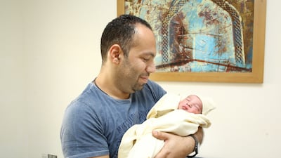 Baby Danial with his father, Ramez Nabil, at Burjeel Hospital in Abu Dhabi. Danial was born at 12.01am on Tuesday. Courtesy: Mounir family